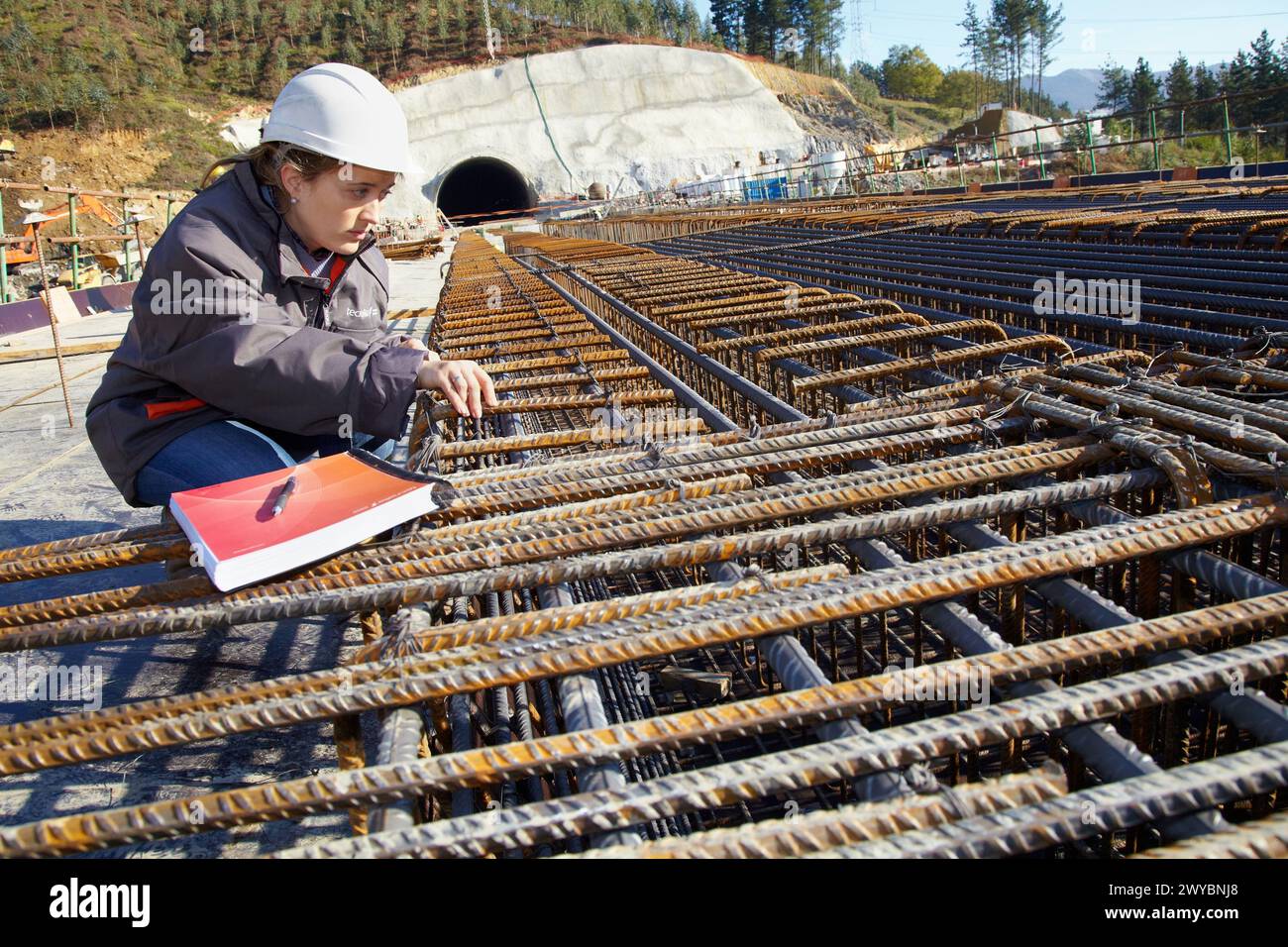 Architect overseeing the installation of rebar, reinforcing steel bars