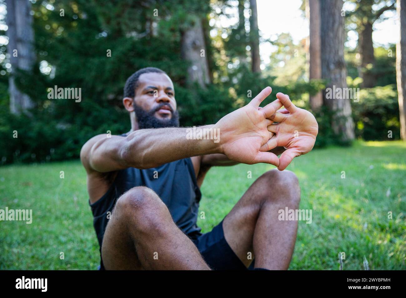 Sporty african man stretching arms hi-res stock photography and images ...