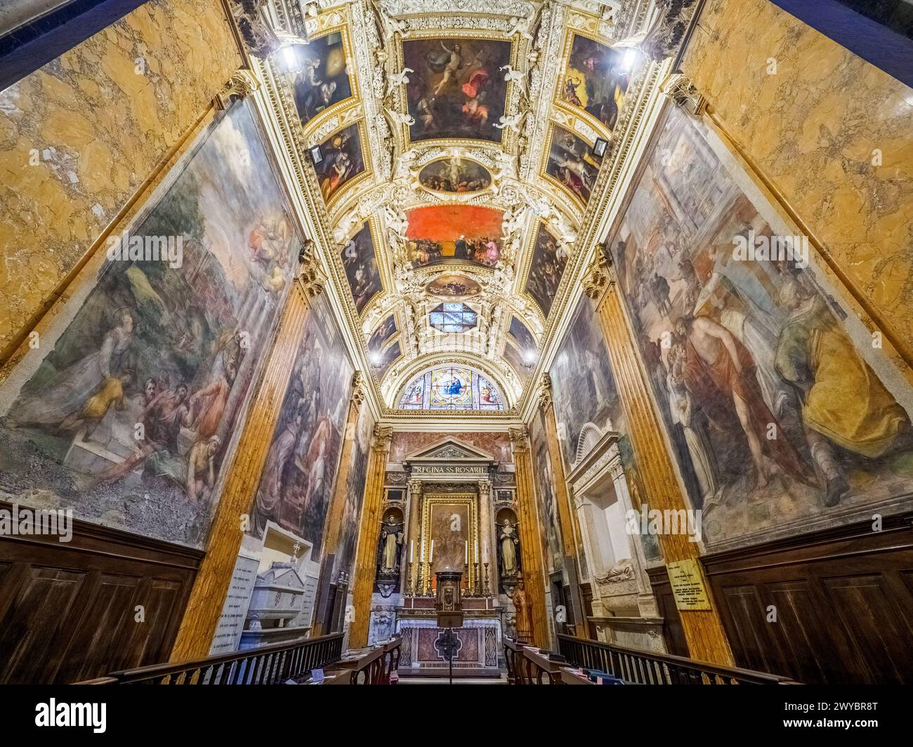 The Capranica chapel is also known as the Chapel of the Rosary. The stucco ceiling was made in 1573 by Marcello Venusti. The chapel contains the tomb of Cardinal Domenico Capranica by Andrea Bregno - Basilica di Santa Maria sopra Minerva - Rome, Italy Stock Photo