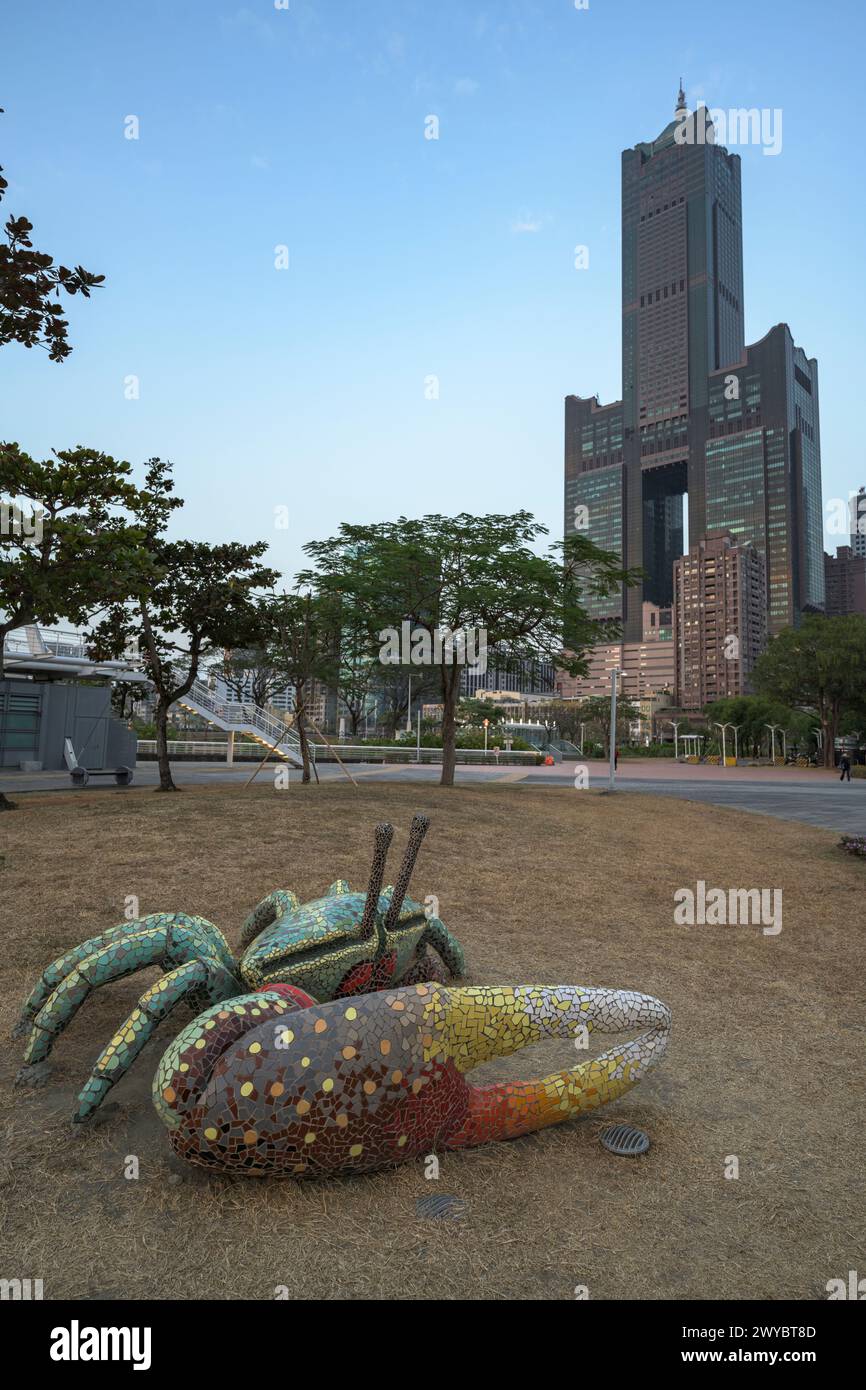 An intricate giant octopus sculpture sprawls across the ground with a modern cityscape rising behind Stock Photo