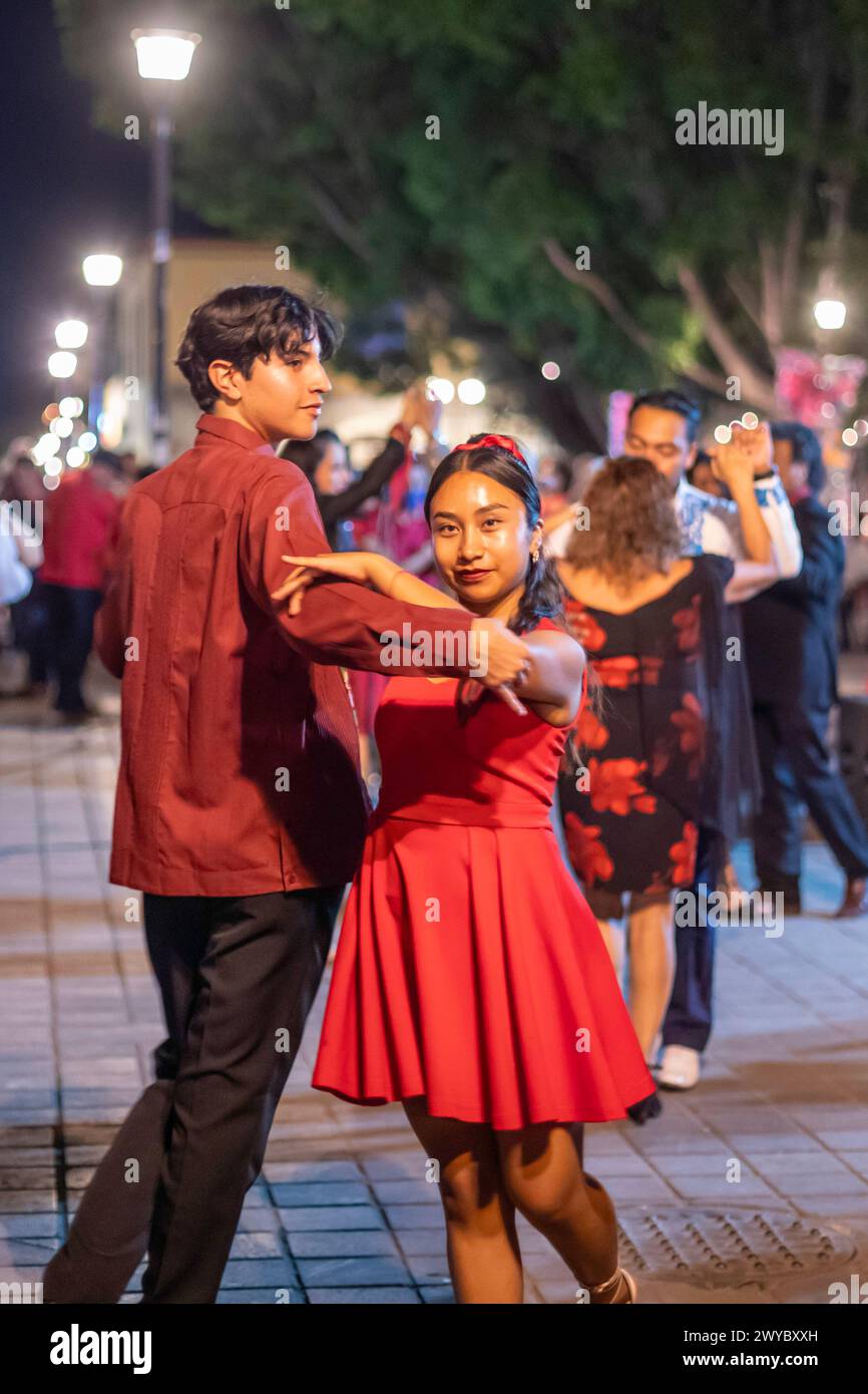 Oaxaca, Mexico - The weekly Wednesday dance in the zocalo, or central square. This night the dance was on Valentine's Day, with many dancers wearing r Stock Photo
