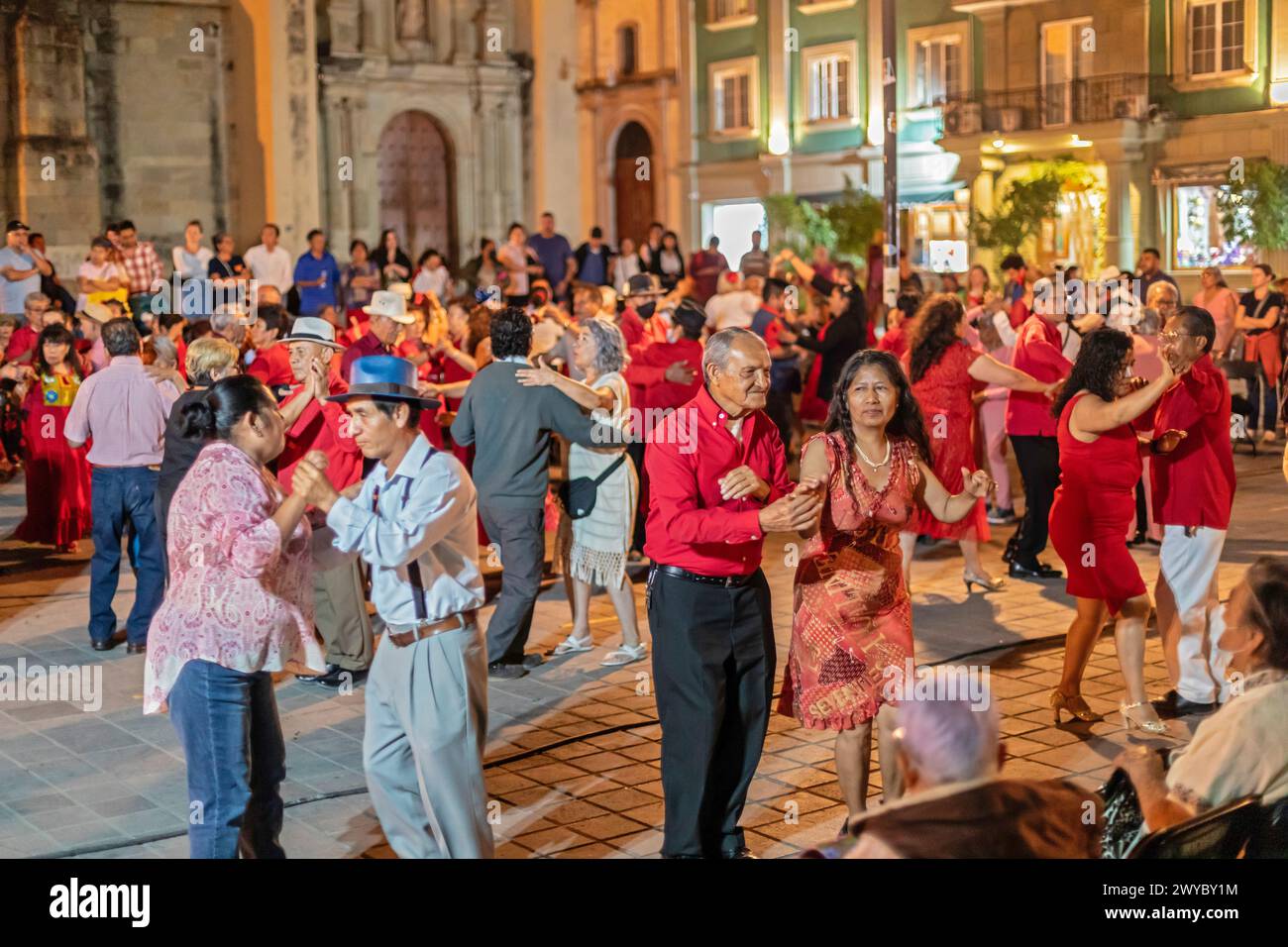 Oaxaca, Mexico - The weekly Wednesday dance in the zocalo, or central square. This night the dance was on Valentine's Day, with many dancers wearing r Stock Photo