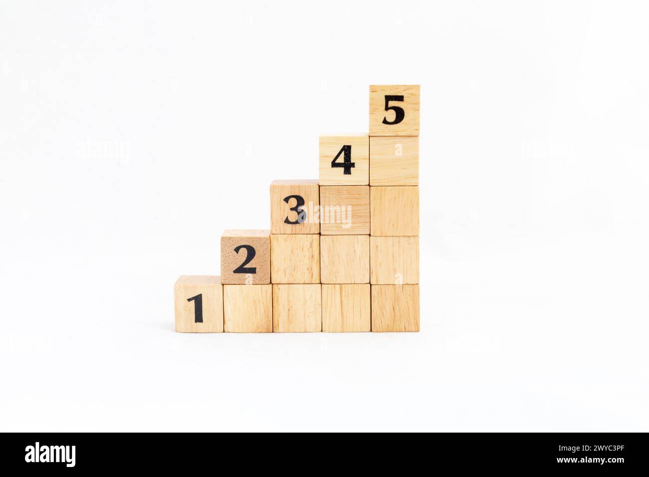 Wooden blocks stacking as step up stair with number 1, 2, 3, 4 and 5 . Business concept for growth and success process. Stock Photo