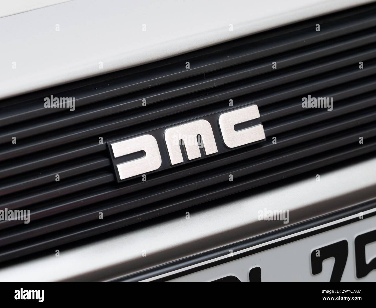 DMC logo sign close up of the DeLorean sports car exterior. Emblem on the front part as detail of the automotive brand. Classic car manufacturer. Stock Photo