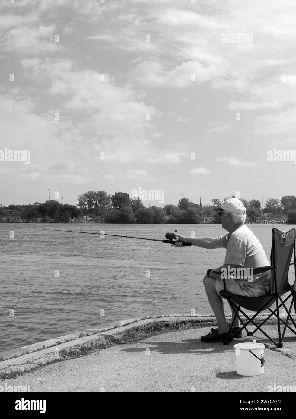 Older man fishes on the Niagra River Canada Stock Photo