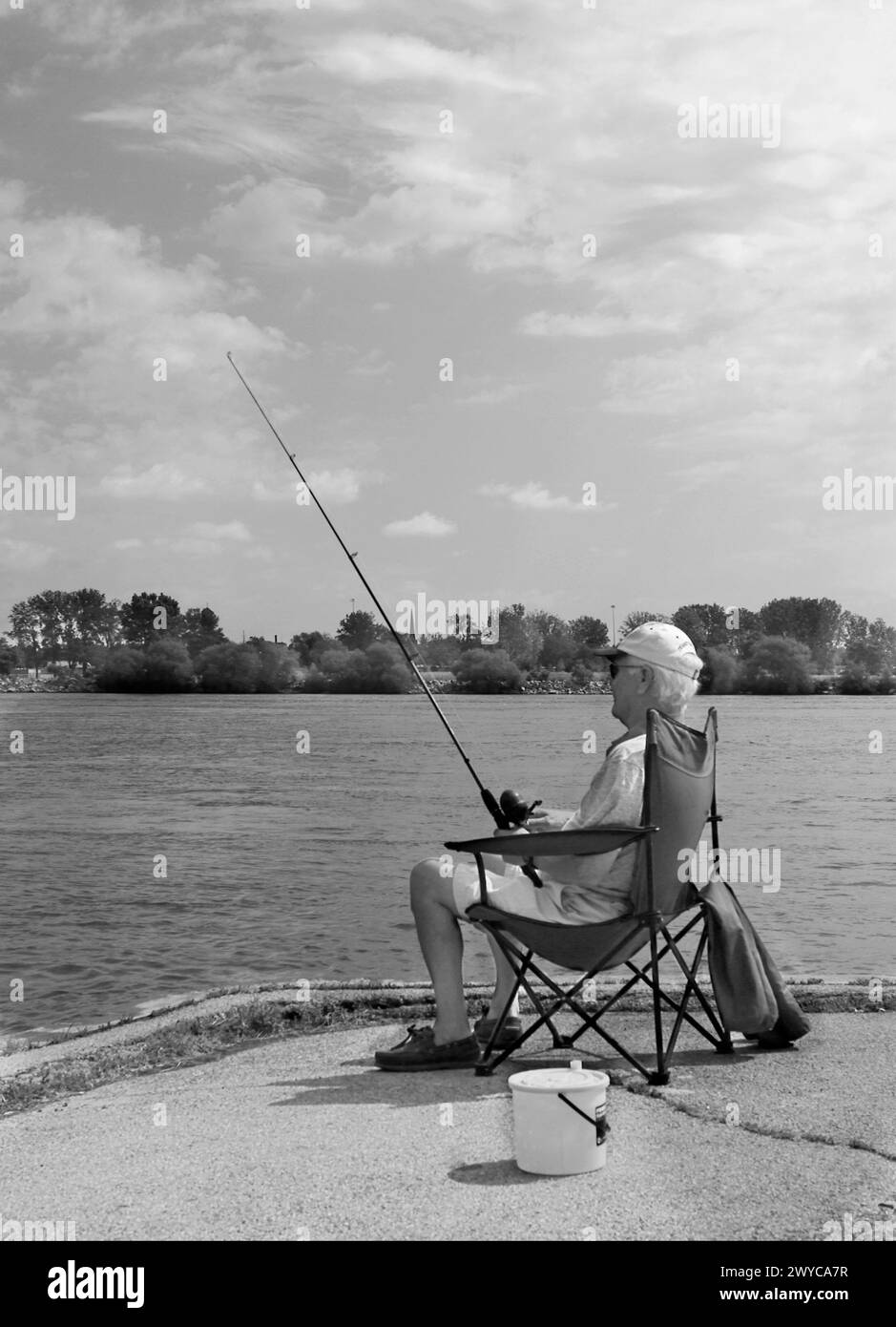 Older man fishes on the Niagra River Canada Stock Photo