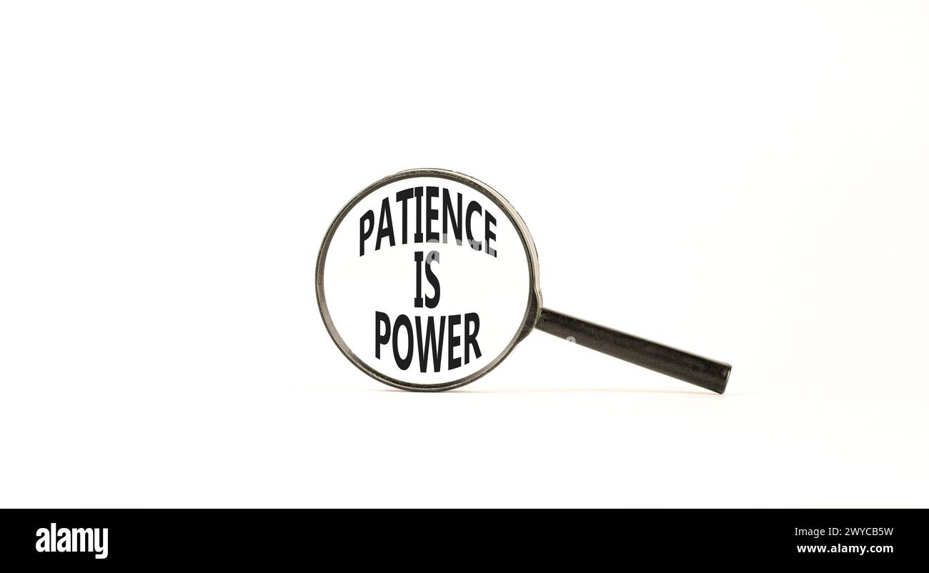 Patience is power symbol. Concept words Patience is power in beautiful magnifying glass. Beautiful white table white background. Business and patience Stock Photo