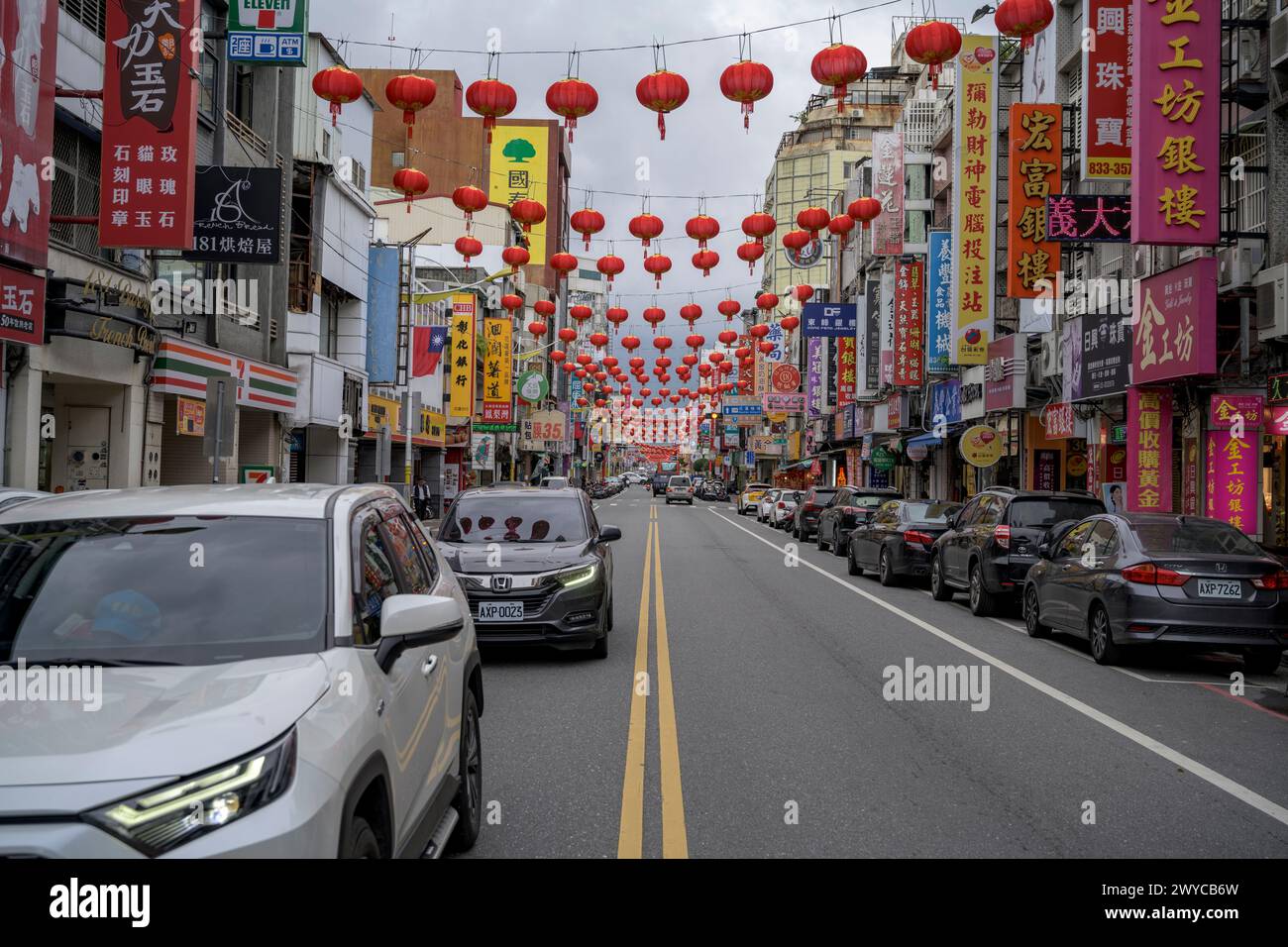 A bustling street scene captures the vibrant essence of an urban district with red lanterns hung above, signaling festivity or cultural celebration Stock Photo