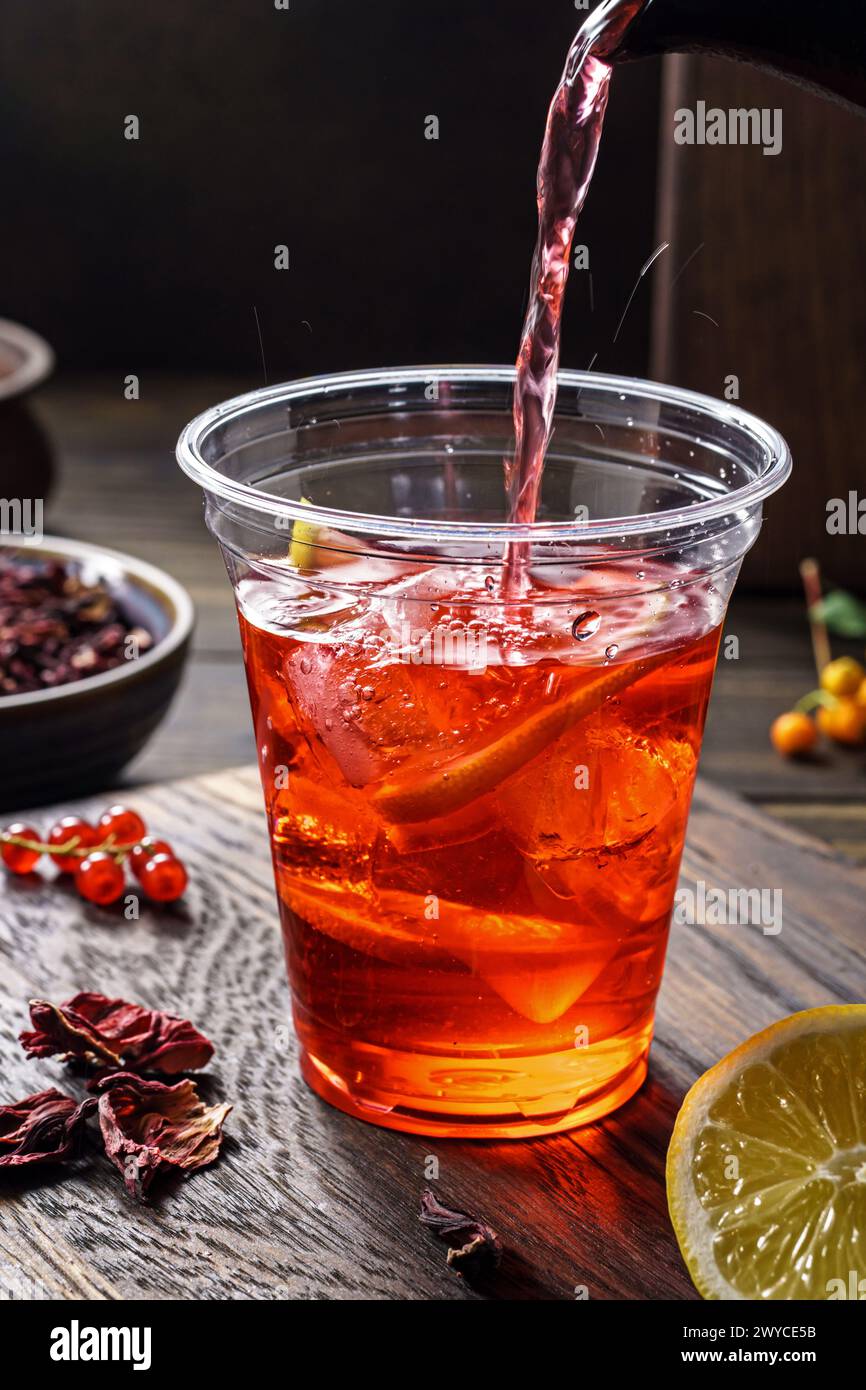 Hibiscus tea pouring.Herbal tea made as an infusion from crimson calyces of roselle flower Stock Photo