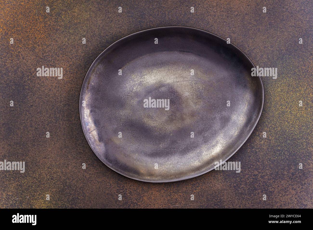 Empty black irregular plate on concrete background. Top view, with copy space Stock Photo