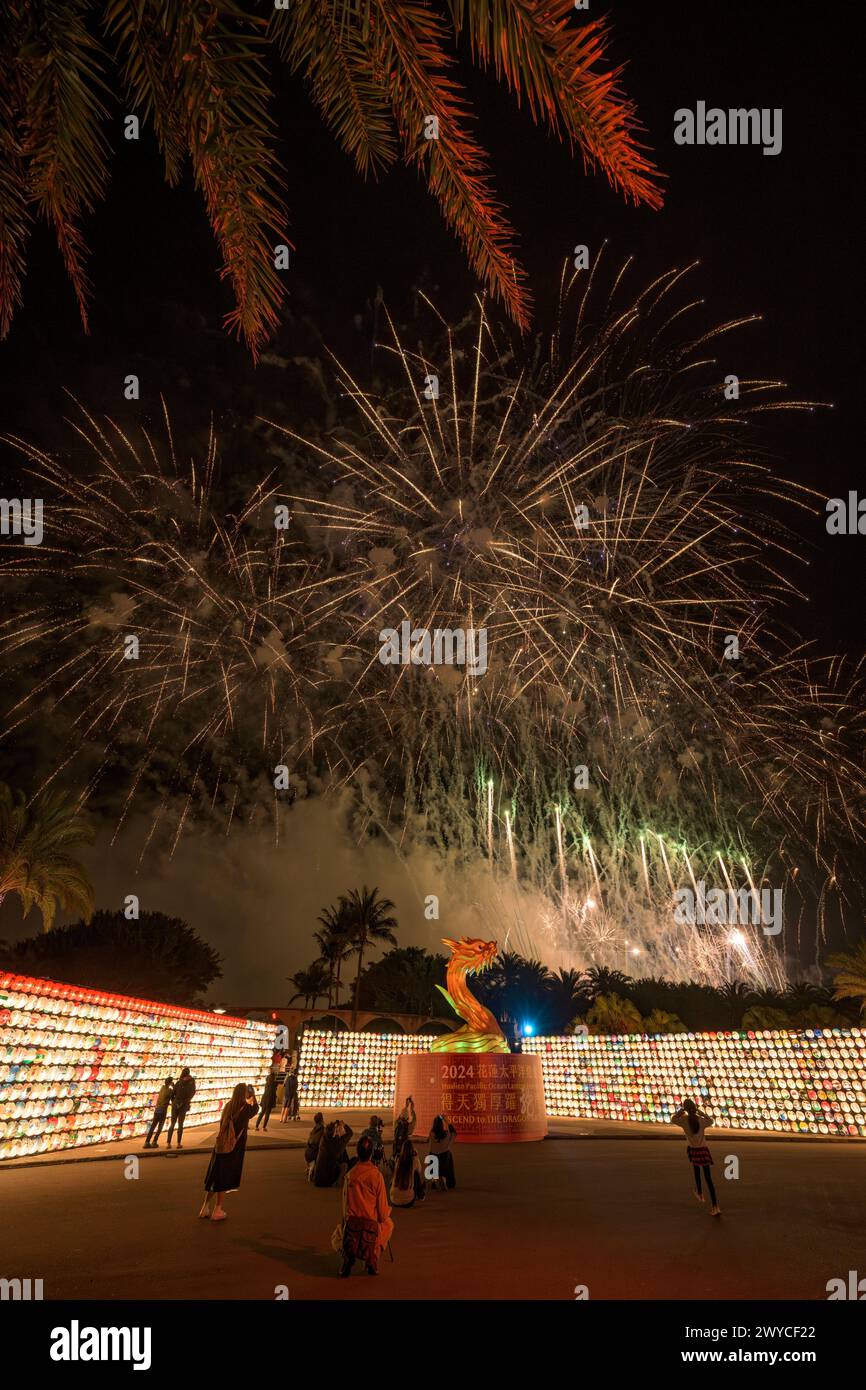 Spectacular fireworks display above a sea of lighted lanterns with a crowd of onlookers Stock Photo