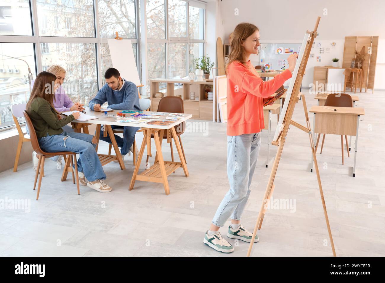 Female student painting on canvas in art school Stock Photo - Alamy