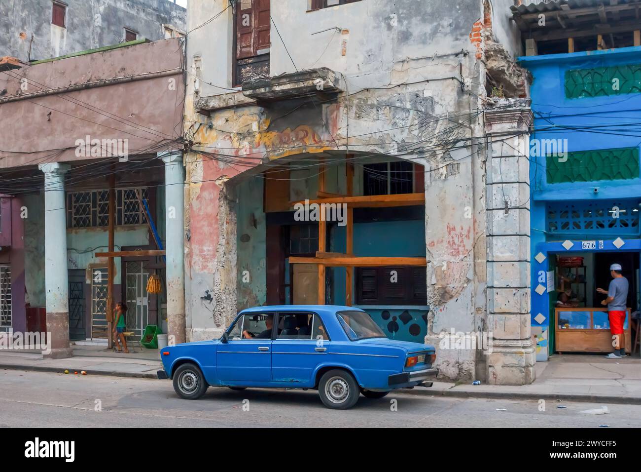 Lada car by weathered damaged facade of buildings in Havana, Cuba Stock Photo