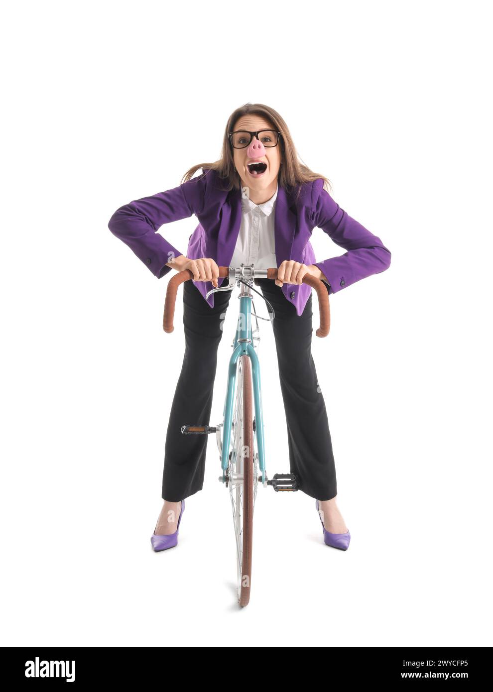 Young businesswoman in funny disguise riding bicycle on white background Stock Photo