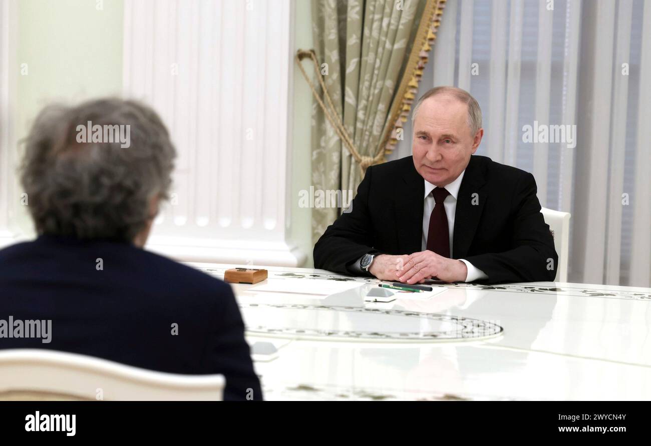 Moscow, Russia. 02 April, 2024. Russian President Vladimir Putin, right, listens to Serbian film director Emir Kusturica, left, during a meeting at the Kremlin, April 2, 2024 in Moscow, Russia. Credit: Mikhail Metzel/Kremlin Pool/Alamy Live News Stock Photo