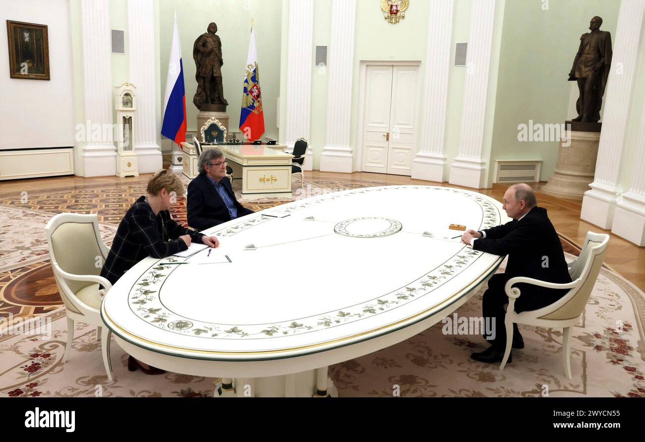 Moscow, Russia. 02 April, 2024. Serbian film director Emir Kusturica, center, listens to Russian President Vladimir Putin, right, during a meeting at the Kremlin, April 2, 2024 in Moscow, Russia. Credit: Mikhail Metzel/Kremlin Pool/Alamy Live News Stock Photo