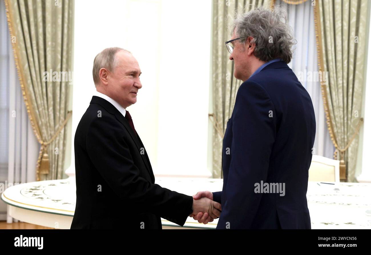 Moscow, Russia. 02 April, 2024. Russian President Vladimir Putin, left, welcomes Serbian film director Emir Kusturica, right, for a meeting at the Kremlin, April 2, 2024 in Moscow, Russia. Credit: Mikhail Metzel/Kremlin Pool/Alamy Live News Stock Photo