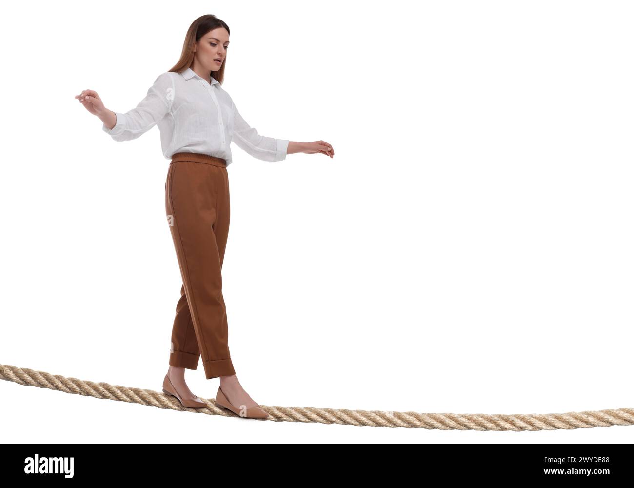 Businesswoman walking rope against white background. Risk or balance concept Stock Photo