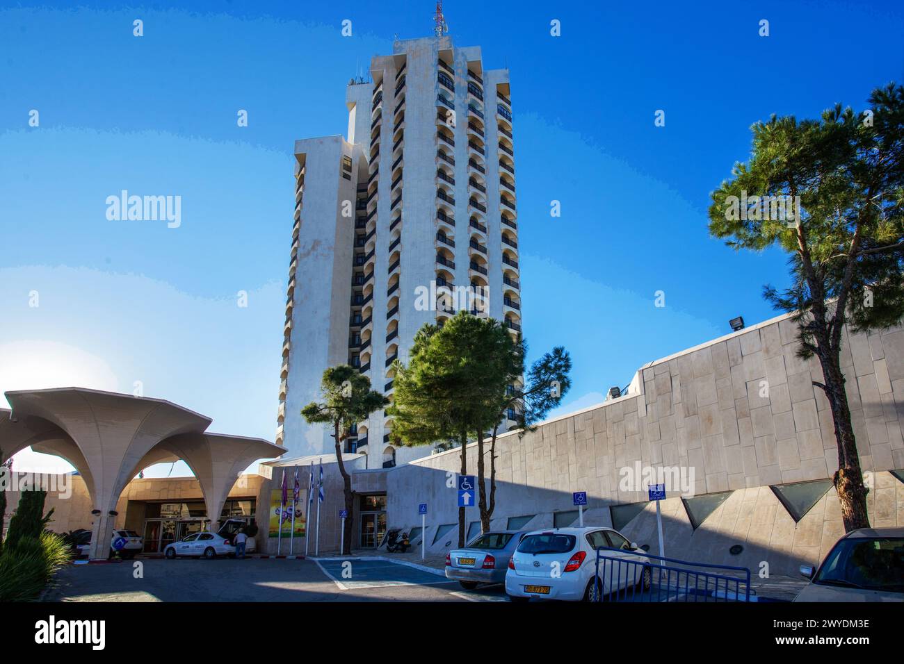 12-25-2014   Jerusalem ISR    Hotel Crown   in amazing sunset and awe pine trees and cars  in parking lots Stock Photo