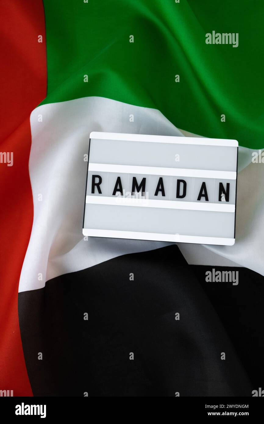 RAMADAN text frame on United Arab Emirates waving flag made from silk ...