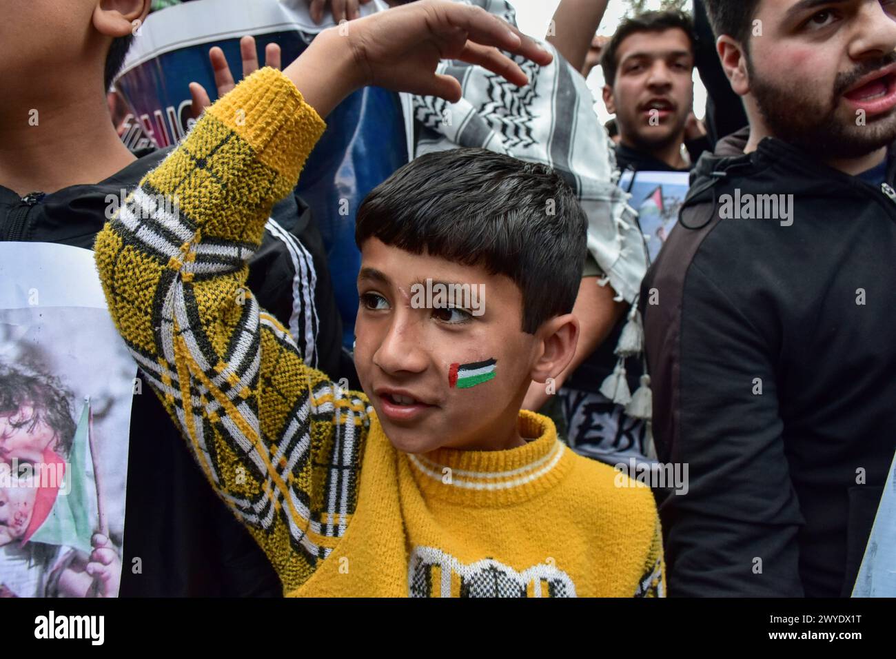 Kashmir, India. 05th Apr, 2024. A Kashmiri Shiite Muslim boy (C) seen ...