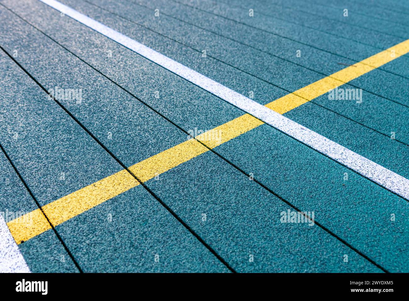 Elevated Platform Tennis, Paddle Ball courts with yellow pickelball lines.  Floor surface is green with white and yellow Stock Photo