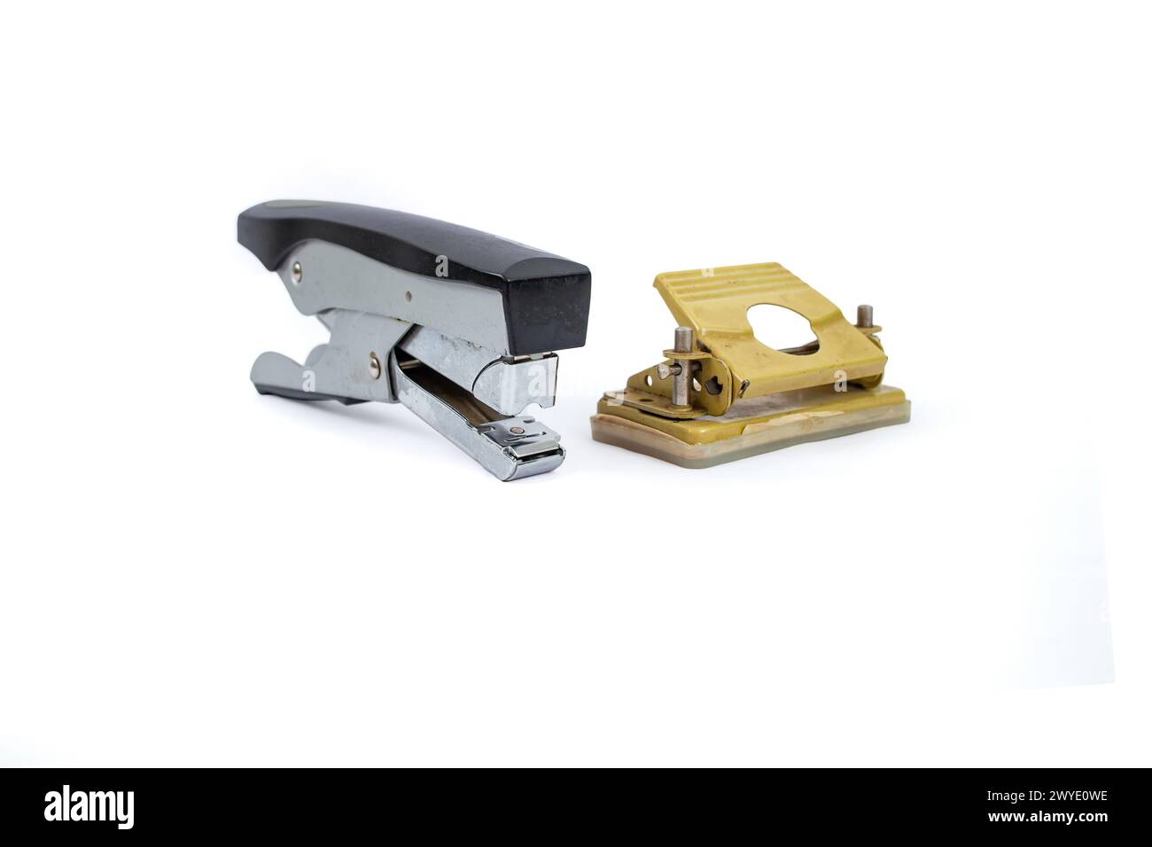 Office supply backdrop, with vintage stapler and perforator isolated on white background, soft focus Stock Photo