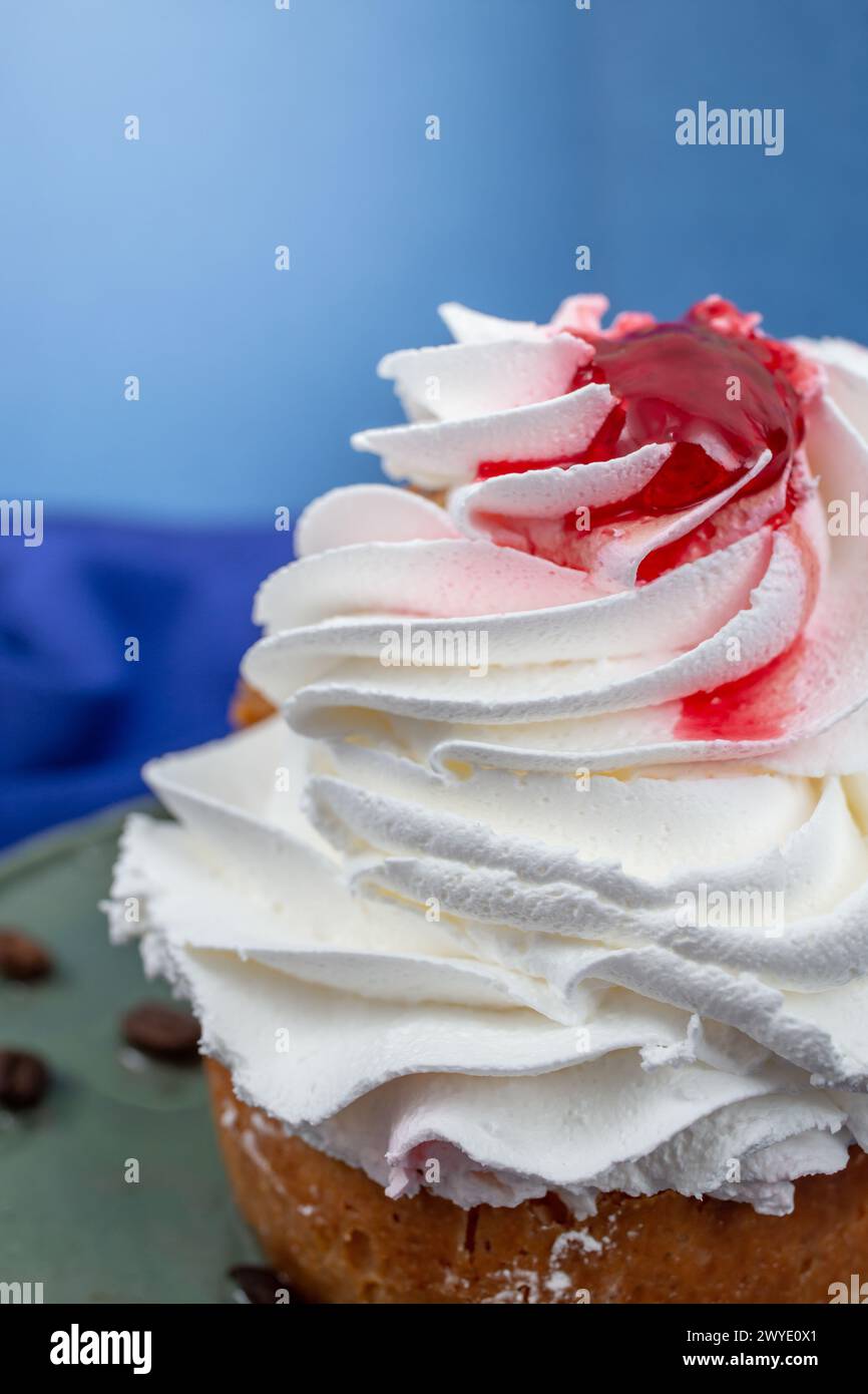 Whipped cream texture on a french savarin cake with red fruit syrup , soft focus crop Stock Photo