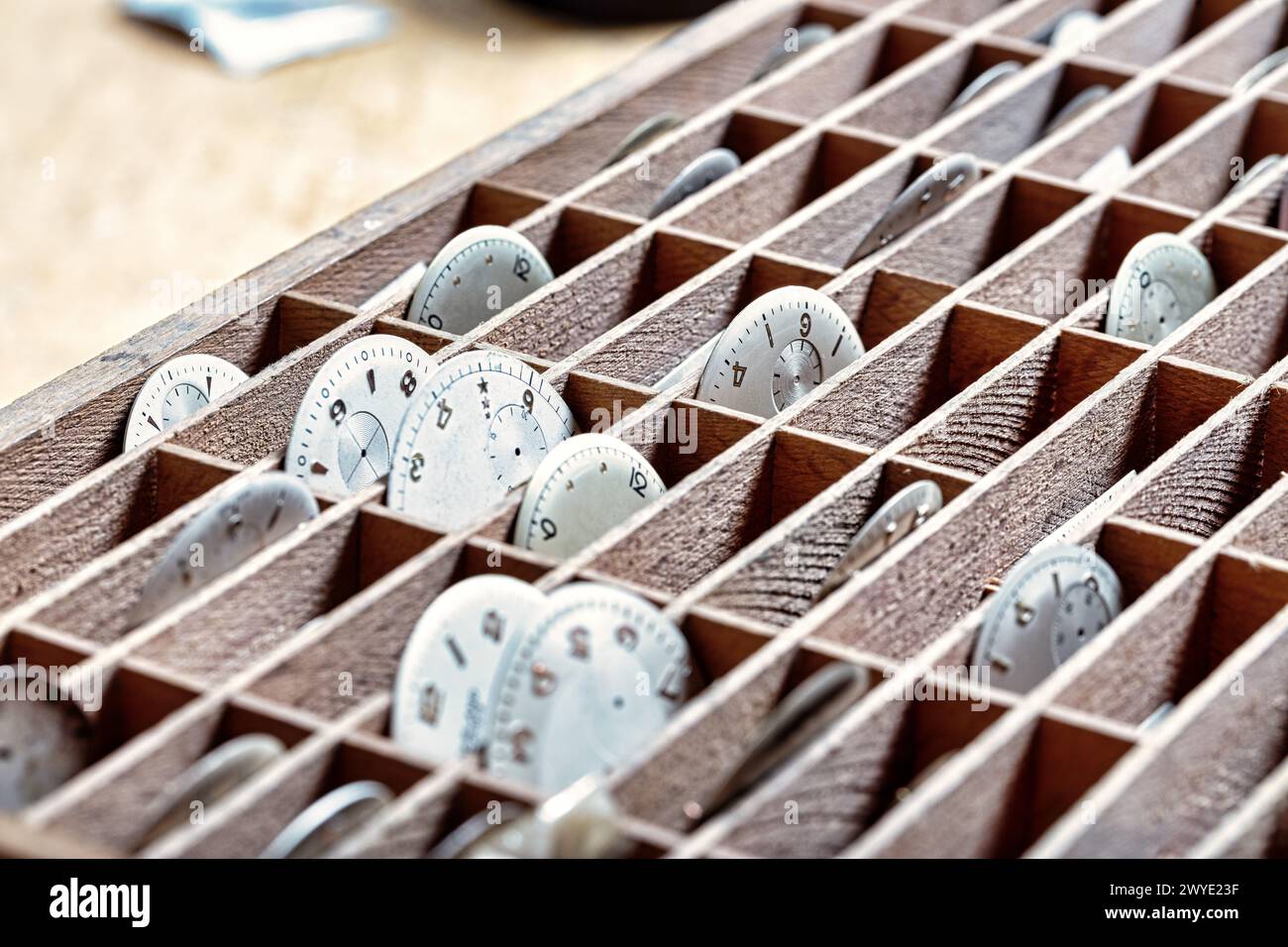 meticulous order of watch dials in compartments, each a frozen moment in the watchmaker's care Stock Photo