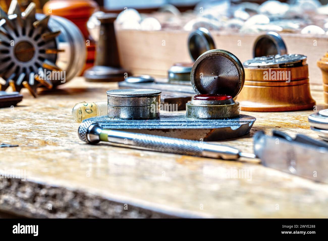 precise art of horology unfolds as a watchmaker sets wheels in motion on a wooden bench Stock Photo