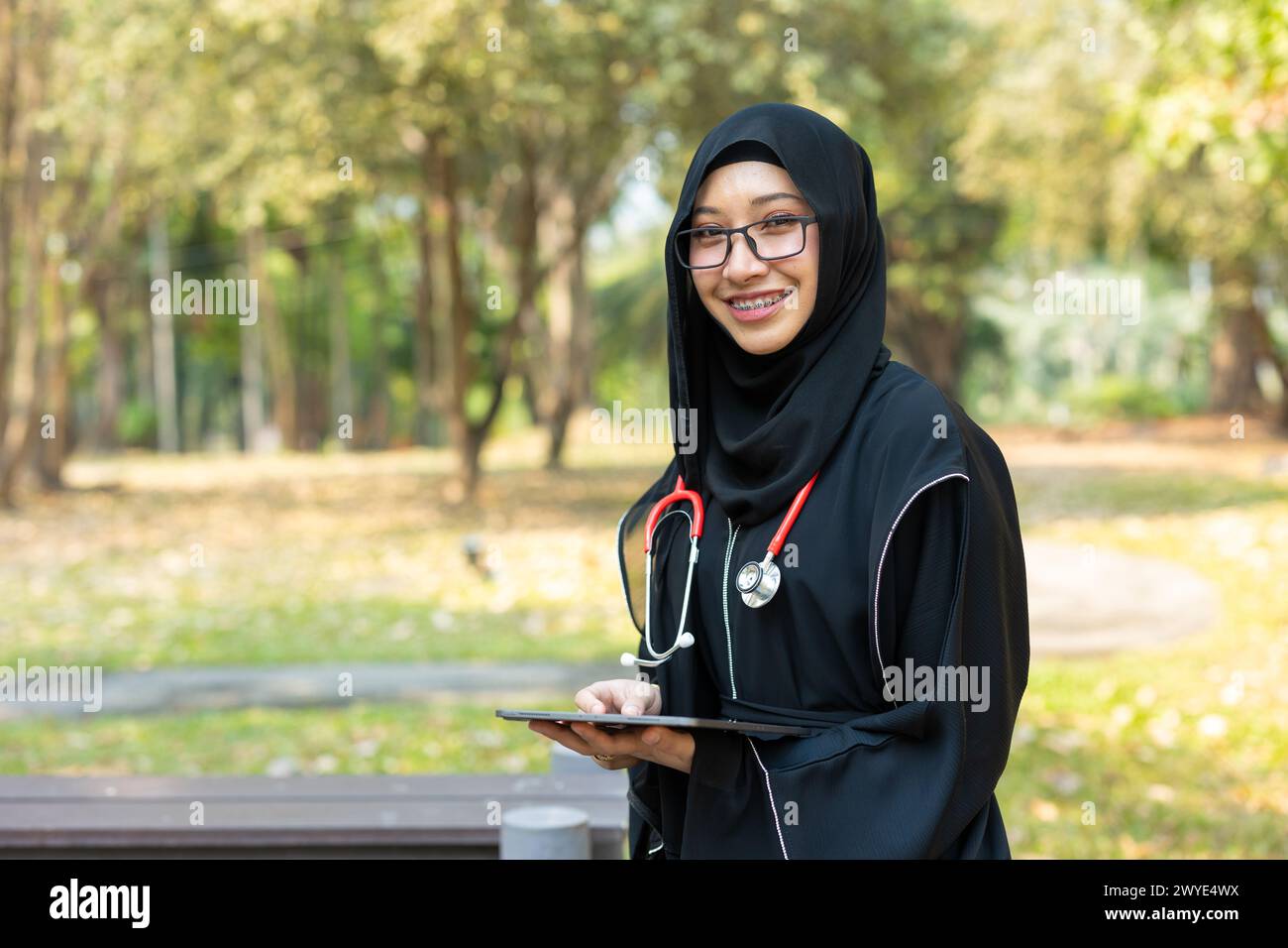 Saudi teen with stethoscope for high education arab women lifestyle in doctor school university campus nature background. Stock Photo