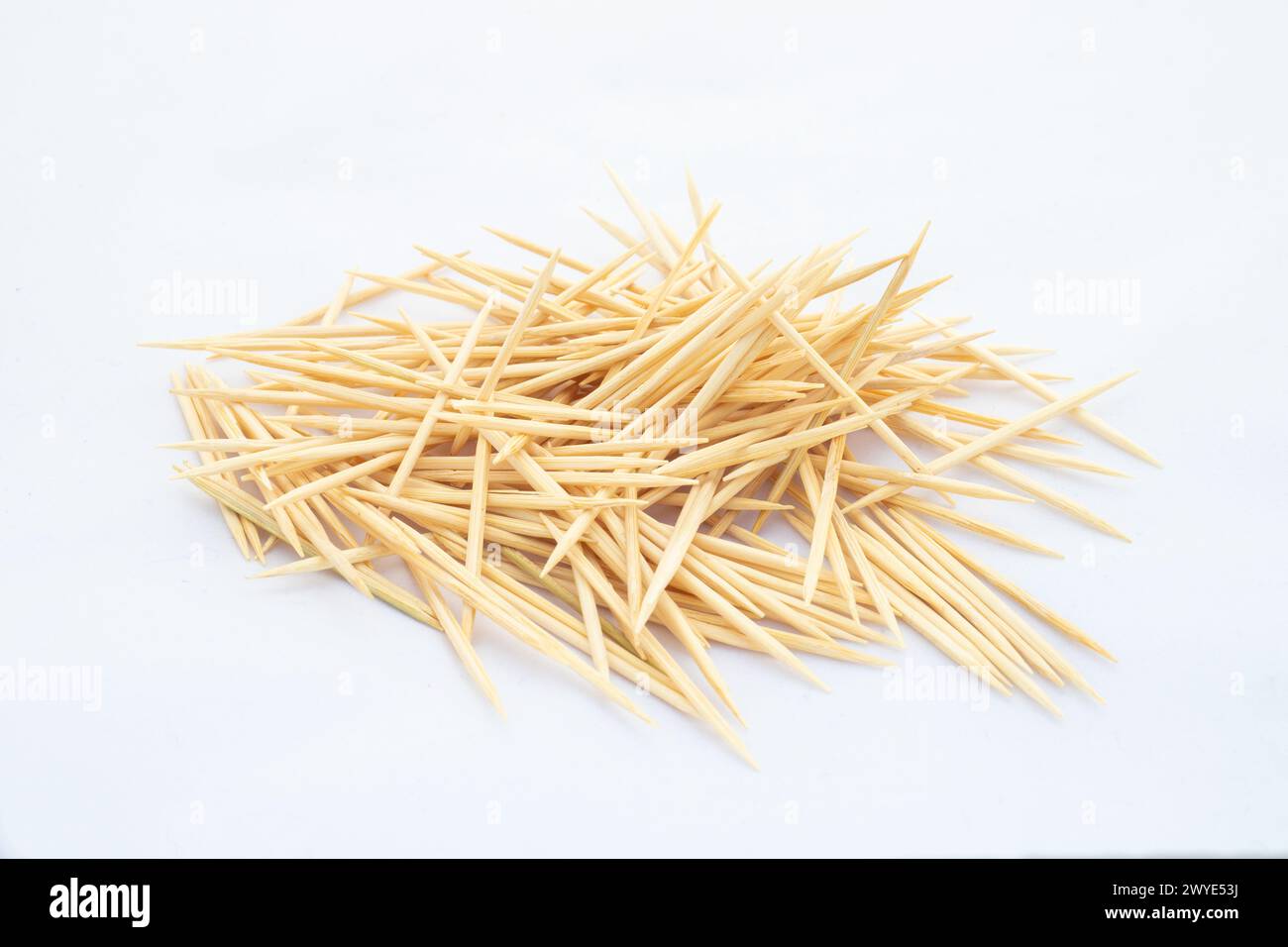 A heap of wooden toothpicks on white isolated background Stock Photo