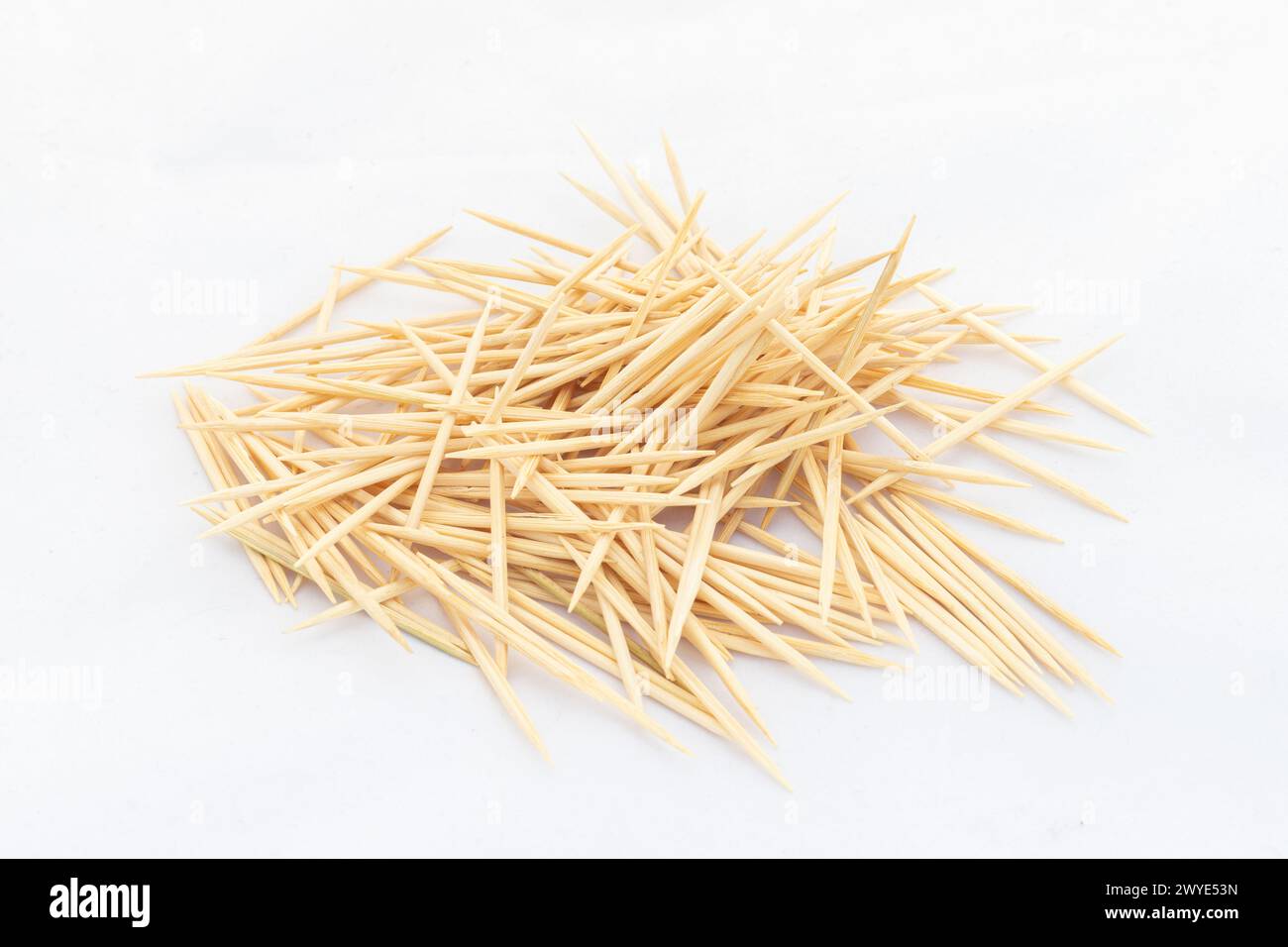 A toothpick is a small thin stick of wood with pointed ends to insert between teeth to remove detritus, usually after a meal Stock Photo