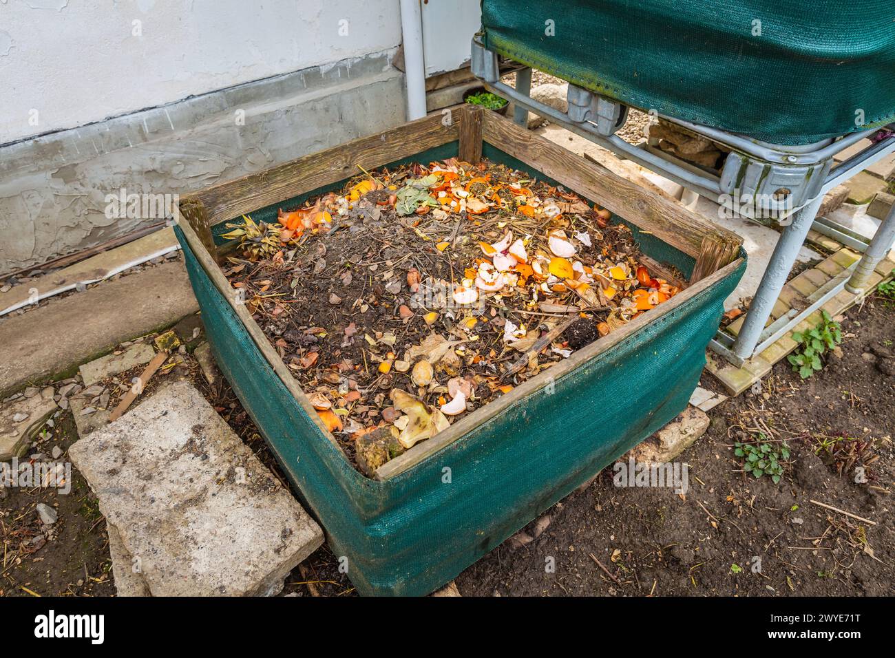 Compost bin with food scraps, grass cuttings, weeds and organic
