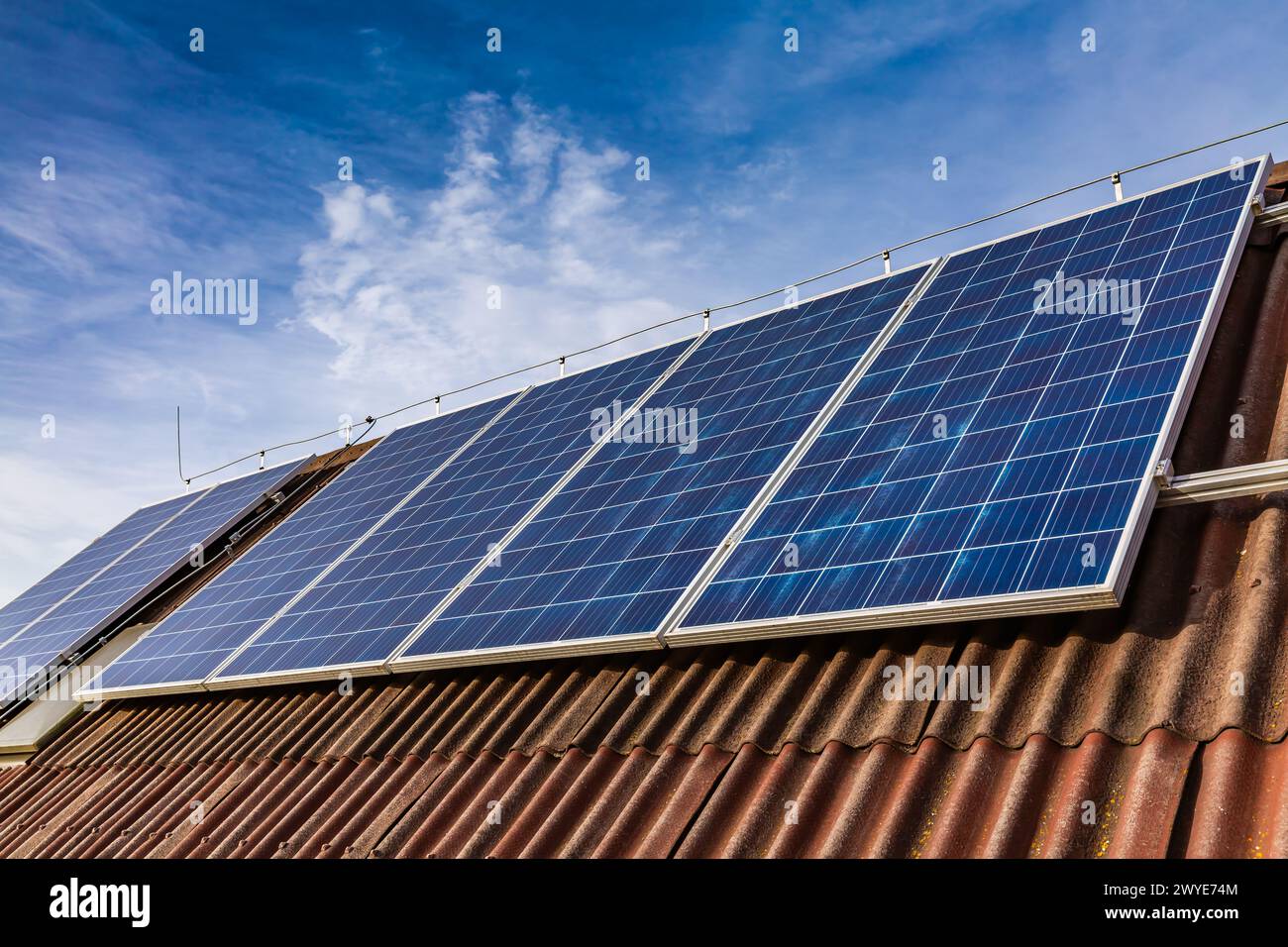 Photovoltaic panels on the roof of family house, solar panels. Environment and technology concepts. Stock Photo
