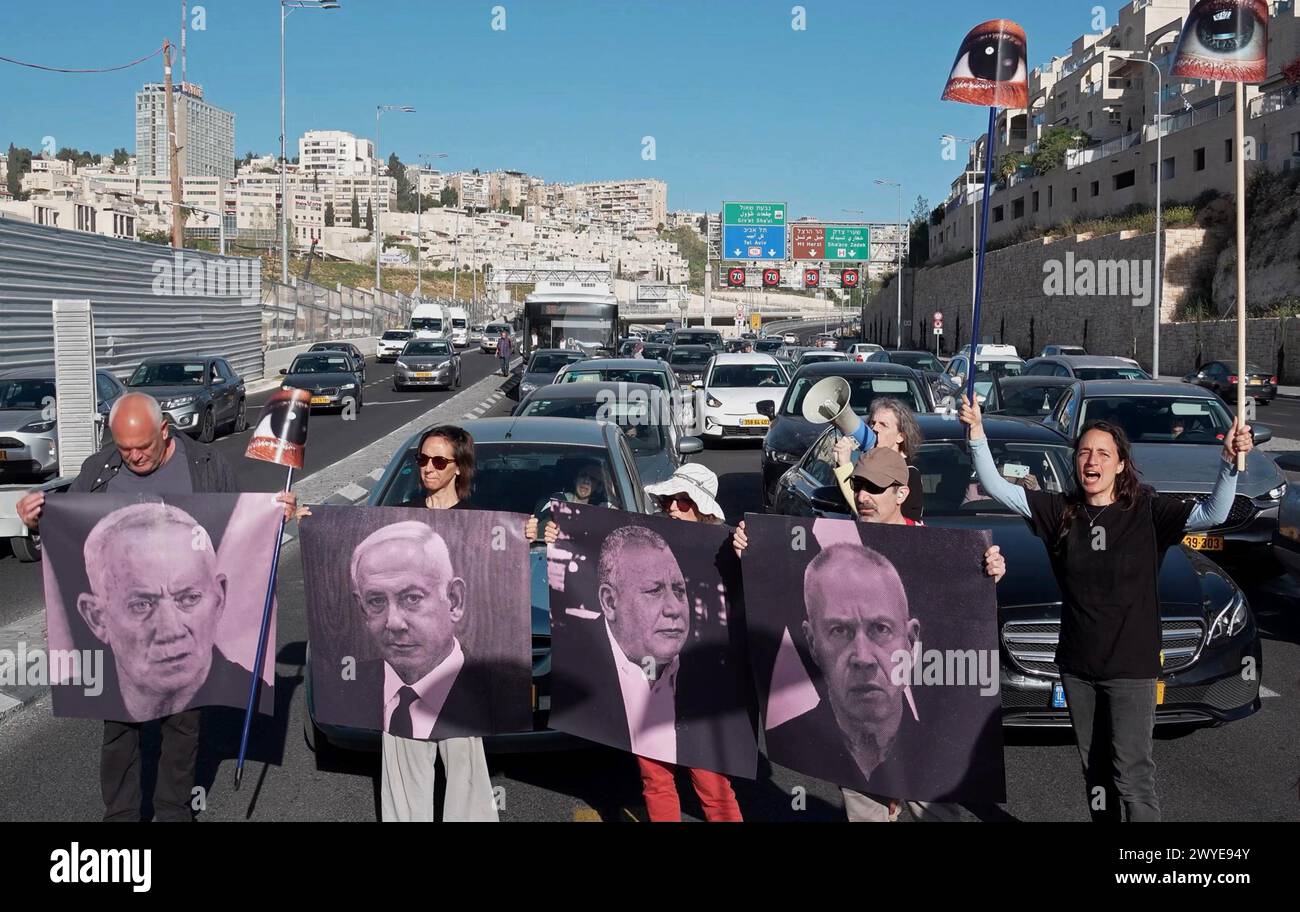 JERUSALEM - APRIL 4: Relatives and supporters of Israeli hostages held in Gaza since the October 7 attacks by Hamas militants hold posters with images of Israeli PM Netanyahu and other cabinet ministers as they chant slogans and block a major motorway during a sudden demonstration calling for the release of hostages held in the Gaza Strip on April 4, 2024 in Jerusalem. Israel Stock Photo