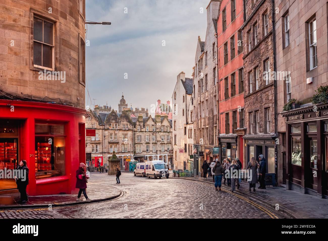 Edinburgh, Scotland - January 22nd, 2024: a bright red storefront and old buildings along West Bow and Victoria Street in Edinburgh Old Town Stock Photo