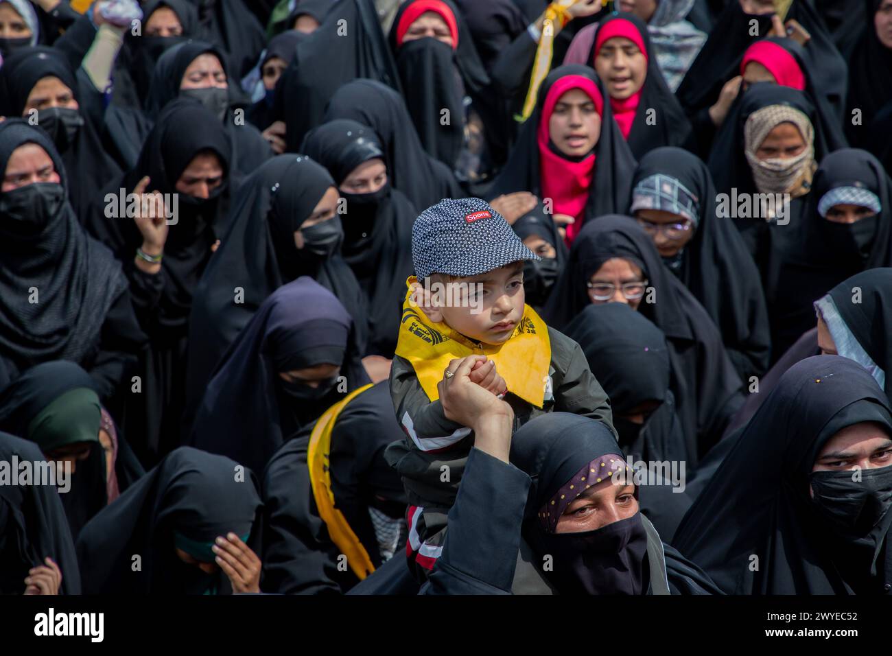 Srinagar, India. 05th Apr, 2024. A Muslim woman holds her child above ...