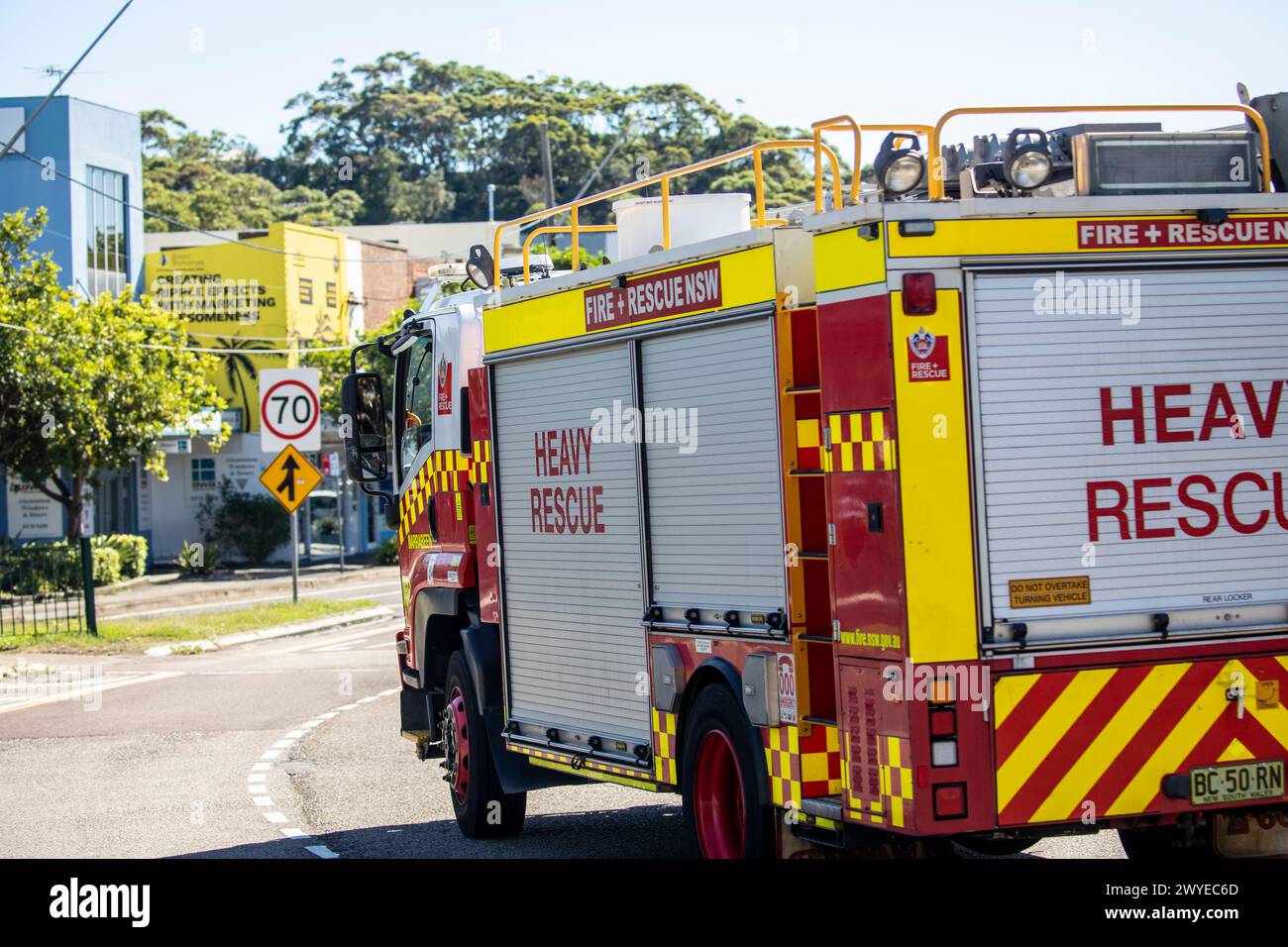 Australia, Fire and Rescue fire engine driving along Pittwater Road in Narrabeen,Sydney,Australia,2024 Stock Photo