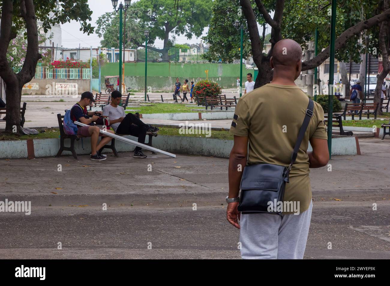 Cuban man tries to cross the street towards a square in Havana, Cuba Stock Photo