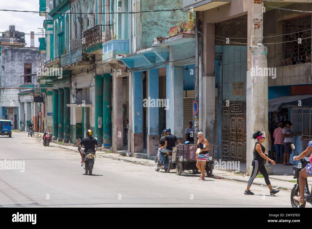Cuban people daily life by weathered buildings in Havana, Cuba Stock Photo