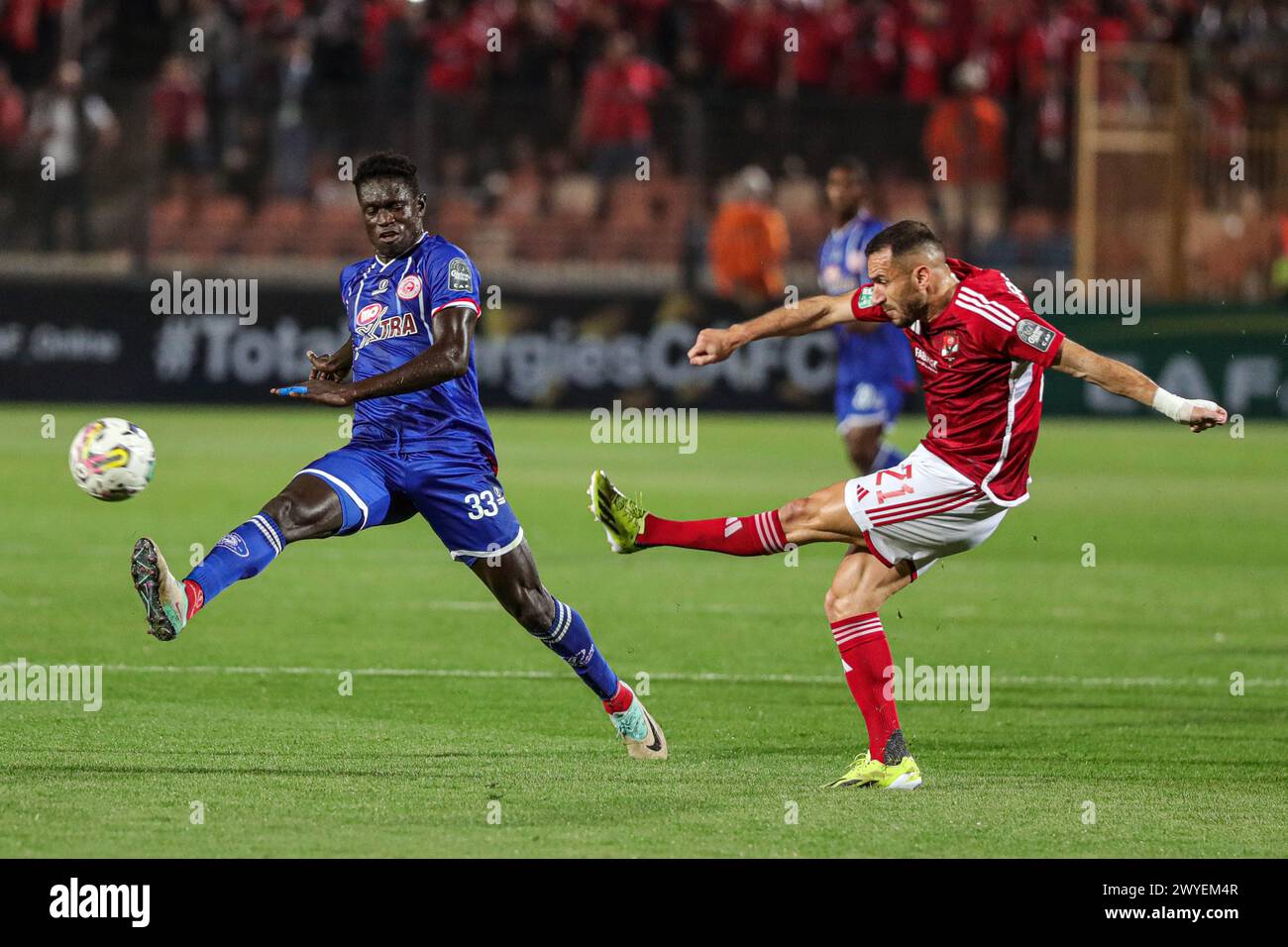 Cairo, Egypt. 5th Apr, 2024. Ali Maaloul (R) of Al Ahly competes with Babacar Sarr of Simba during the CAF Champions League quarter-final match between Al Ahly of Egypt and Simba of Tanzania in Cairo, Egypt, April 5, 2024. Credit: Ahmed Gomaa/Xinhua/Alamy Live News Stock Photo
