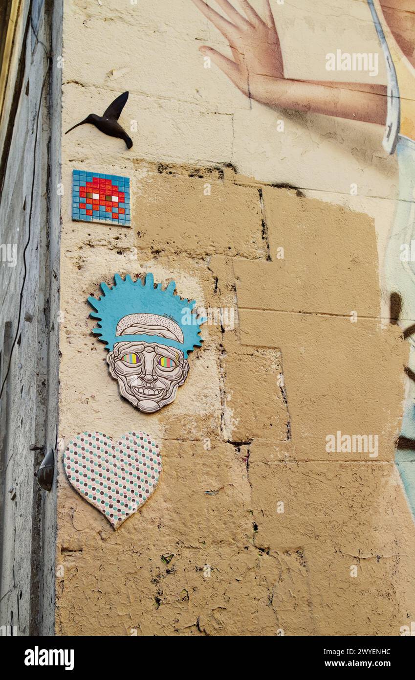 Different Street Art On The Corner Of A Building Including A Tiled ...