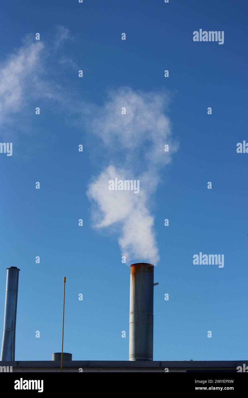 Environmental pollution. Industrial chimneys for exhaust emissions. Smoke from an industrial chimney. Stock Photo
