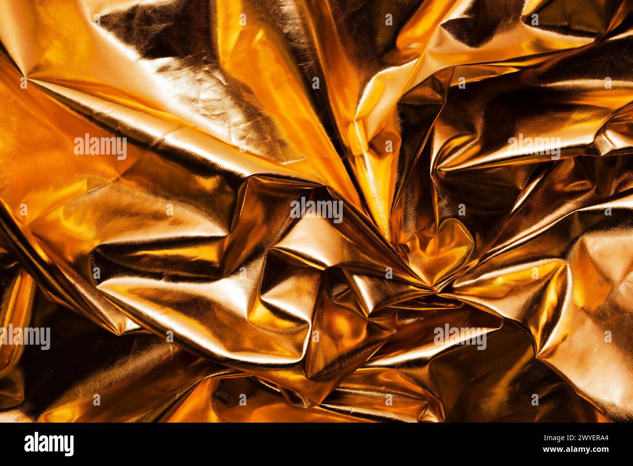 crumpled gold metallic reflector background texture Stock Photo