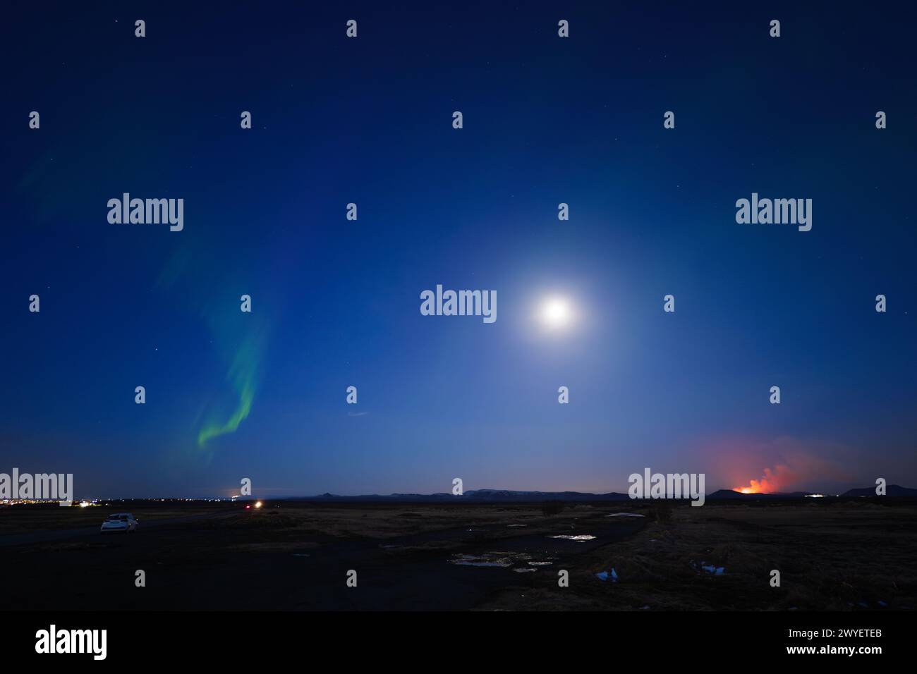 Northern Lights and Volcano Eruption During Blue Hour with Full Moon in