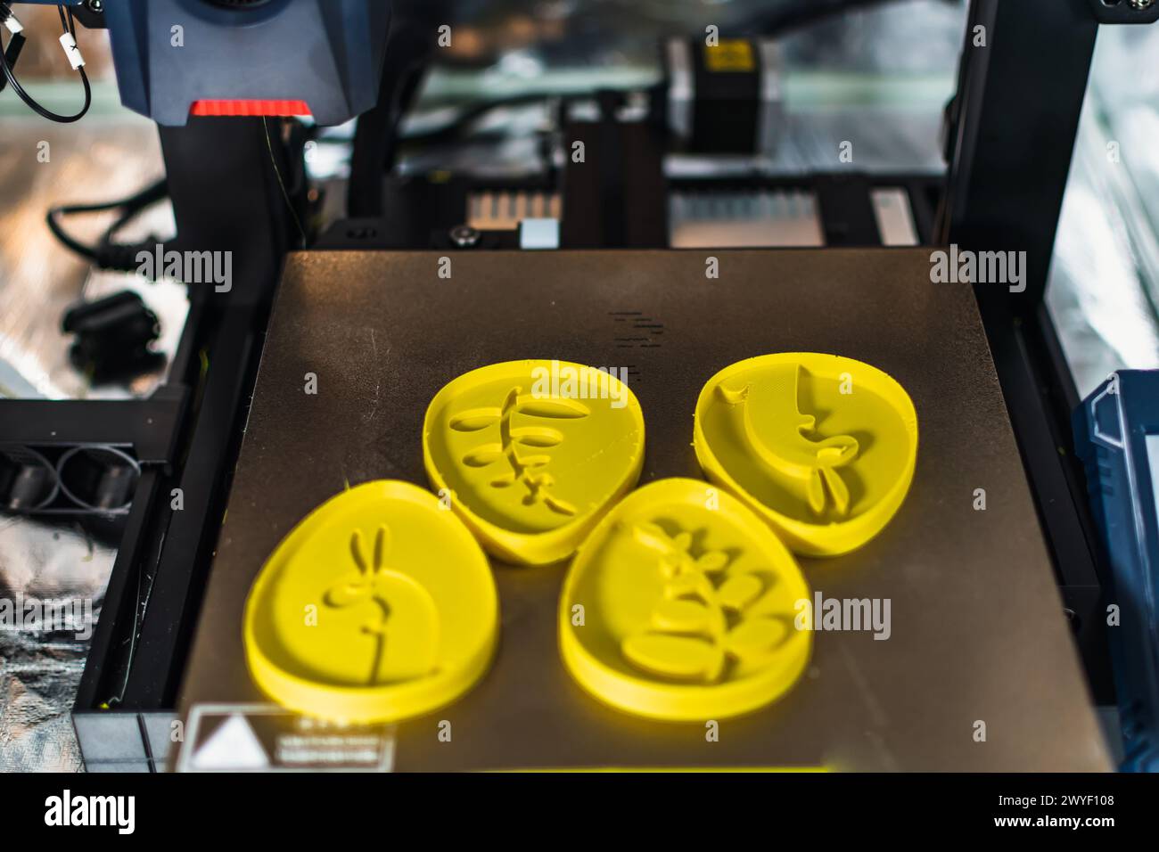 3d printer with some objects on the tray printed with pla filament Stock Photo