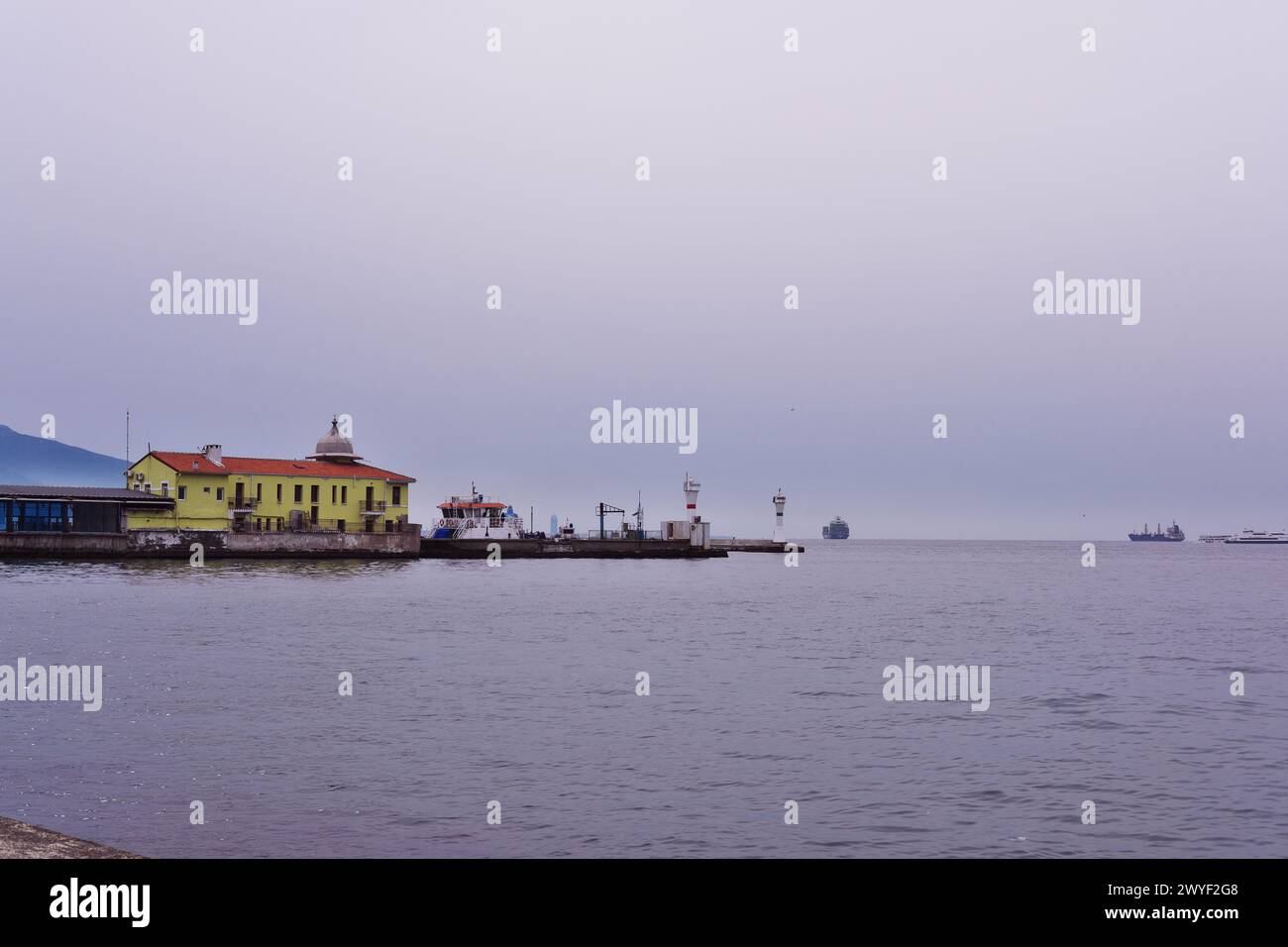 Seaside of Izmir Pasaport neighborhood with cith ferries and beacon at sea Stock Photo