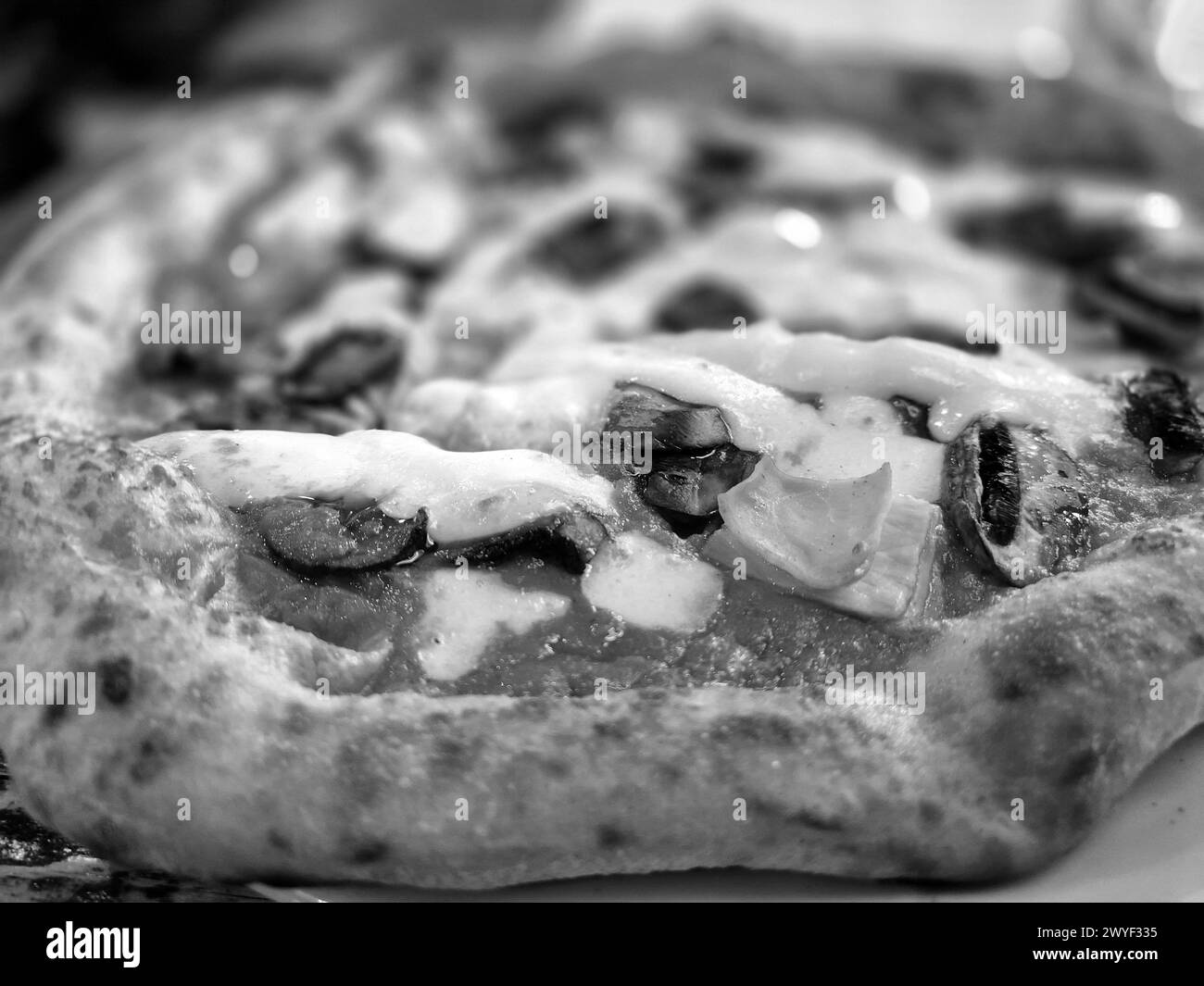 Tasty pizza close view background. Black and white pizza photo Stock Photo