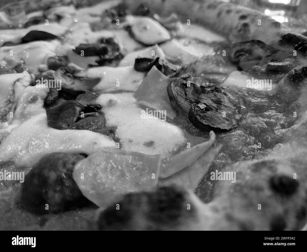 Tasty pizza close view background. Black and white pizza photo Stock Photo
